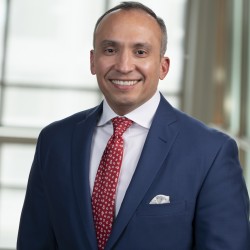 Carlos Gutierrez Headshot in suit and red tie