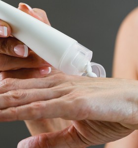 person applying lotion to hands