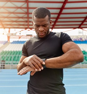 Athlete Outside with Fitness Tracker on a running track