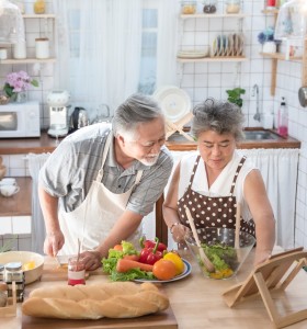 elderly couple of east Asian descent cooking together