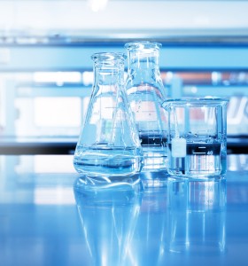 two flasks and a beaker on a table in a lab