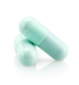 blue green capsules on white background