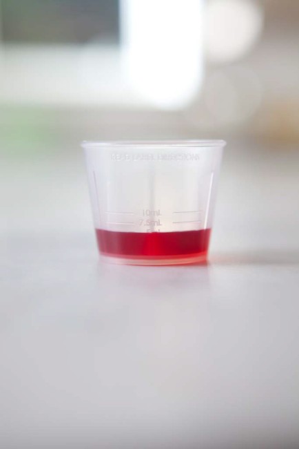 Dosing Device-Dosing Cup with Red Liquid Medicine