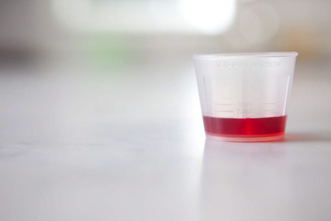 Dosing Device-Dosing Cup with Red Liquid Medicine