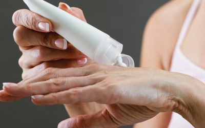 person applying lotion to hands