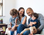 multi-racial couple with two children in living room
