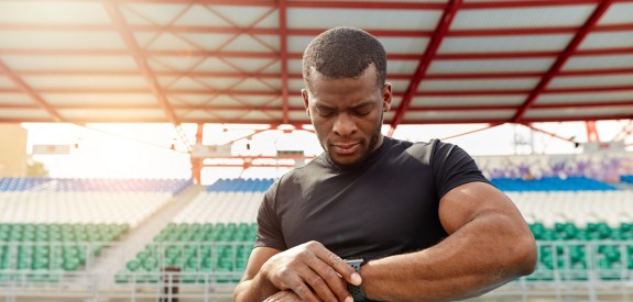 Athlete Outside with Fitness Tracker on a running track