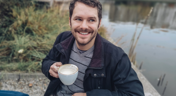 Man outdoors with a Cup of Coffee