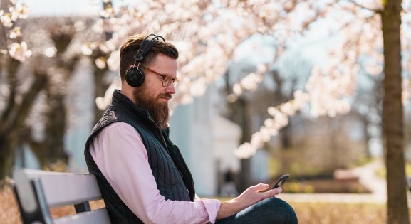 Man Outside Listening to Podcast