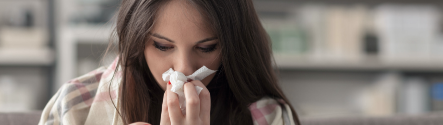 Woman in blanket with tissue