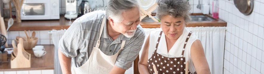 elderly couple of east Asian descent cooking together