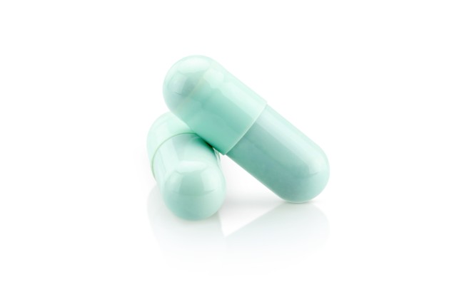 blue green capsules on white background